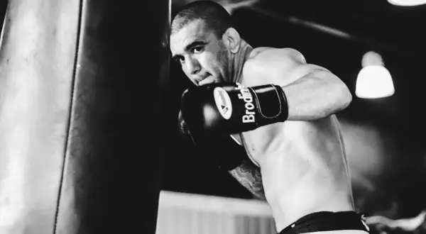 Boxer throws a powerful punch, demonstrating what is a check hook.