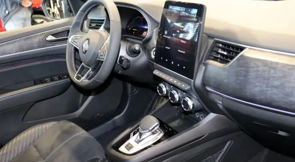 L'intérieur du Renault Arkana dévoile un écran tactile moderne, un volant multifonction et une console centrale épurée.