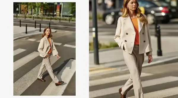 Elegancka beżowa marynarka damska w połączeniu z jasnymi spodniami i pomarańczową bluzką tworzy stylowy miejski look.