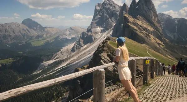Dziewczyna podziwia spektakularne **dolomity co zobaczyć** – skaliste szczyty i zielone doliny.