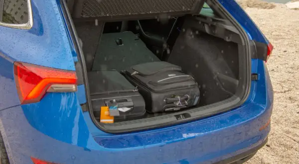 Två resväskor står i det blå Skoda Scala bagageutrymmet.