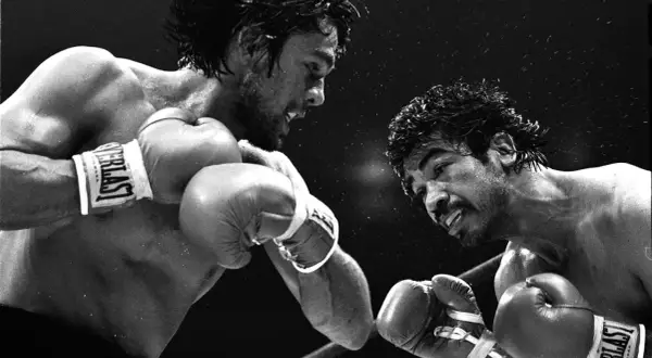 Roberto Duran in a fierce boxing match, a moment captured from his legendary roberto duran fights list.