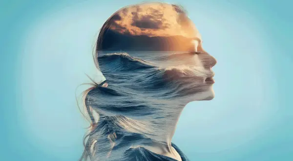 Profilo di donna sovrapposto a onde marine e tramonto, un'immagine che evoca l'ansia a caso, come un mare in tempesta dentro di sé.