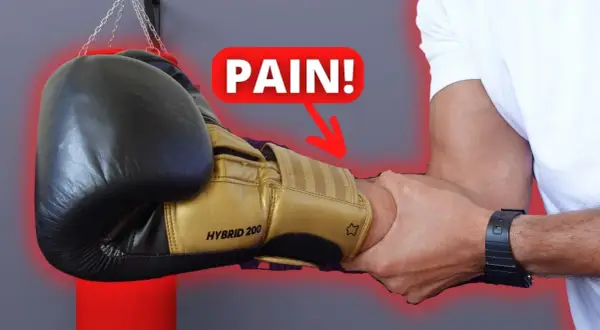 A boxer's forearm is being gripped, with a "PAIN!" graphic and arrow pointing to the wrist. Do strong forearms help you punch harder?