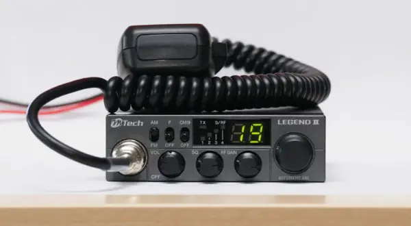 Szary radiotelefon CB MTech Legend II z mikrofonem na skręconym kablu.