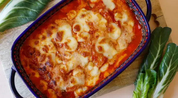 Piatto di coste alla piemontese gratinate al forno, con formaggio fuso e pomodoro. Un classico della cucina piemontese.