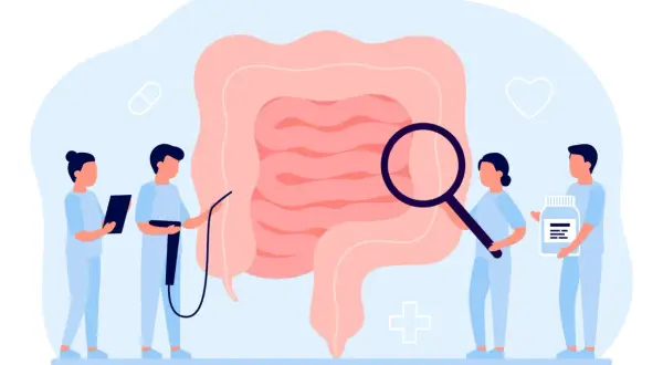 Medici esaminano un intestino ingrandito, simbolo di diagnosi e cura per la colite ulcerosa. Uno tiene una pillola, un altro una bottiglia di farmaci.