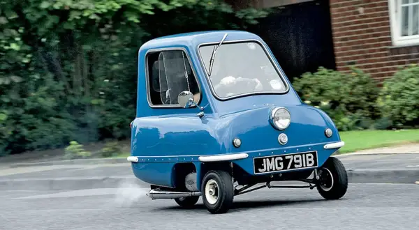 Niebieski Peel P50, najmniejszy samochód świata, w ruchu. Zastanawiasz się nad peel p50 cena?