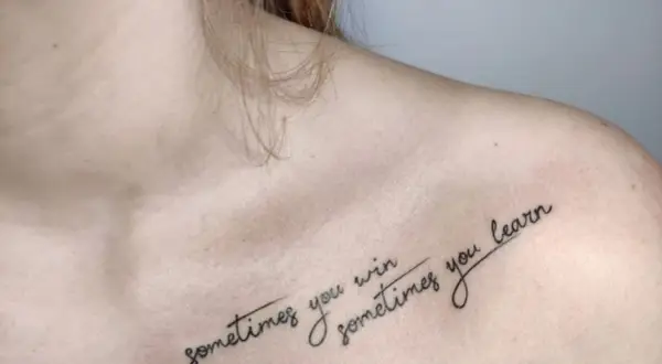 Delikatny tatuaż na dekolcie z napisem "sometimes you win, sometimes you learn".