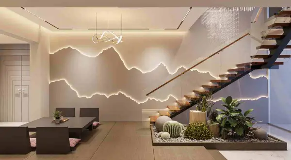 Illuminazione moderna con punti luce casa che seguono il profilo di montagne stilizzate. Scala in legno e vetro, zona pranzo bassa e un angolo verde con cactus.