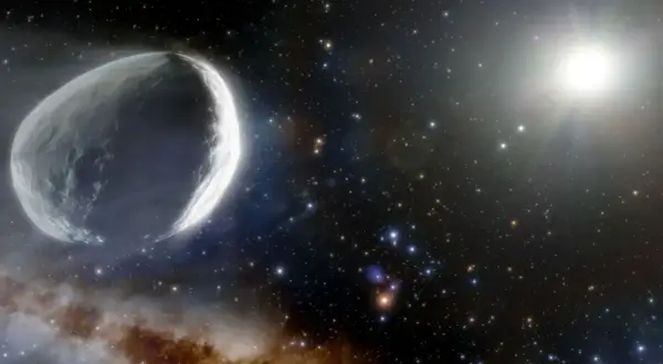 Un gros poisson comète taille adulte, illuminé par le soleil, traverse un champ d'étoiles et de nébuleuses.