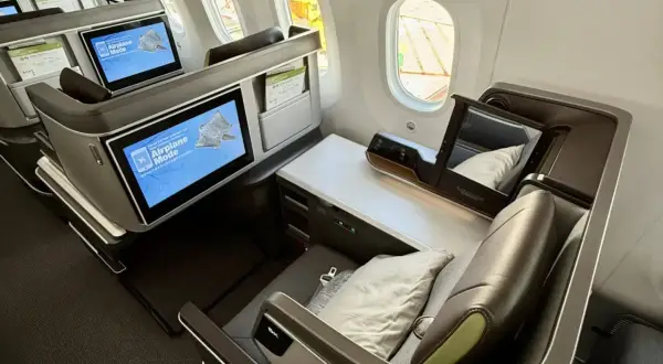 Luxuriöse Business-Class-Sitze von Eva Air. Die Bildschirme zeigen "Airplane Mode". Eine gute Eva Air Bewertung ist hier sicher!