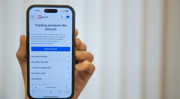 Na ekranie telefonu widoczny jest proces składania wniosku o paszport dla dziecka na stronie gov.pl.