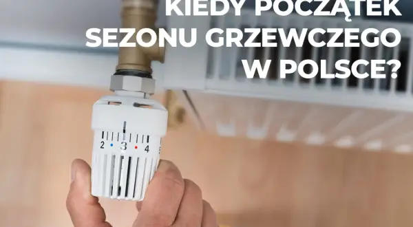 Dłoń reguluje termostat grzejnika. Kiedy rozpoczyna się sezon grzewczy w Polsce?
