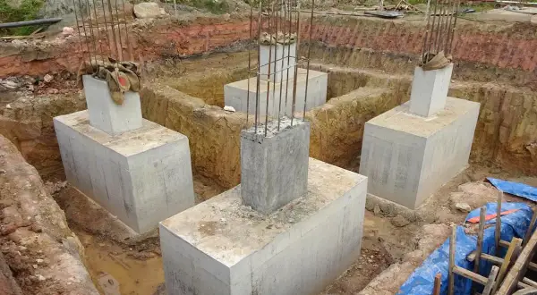Scavi per il consolidamento terreno di fondazione con pilastri in cemento armato pronti per la costruzione.