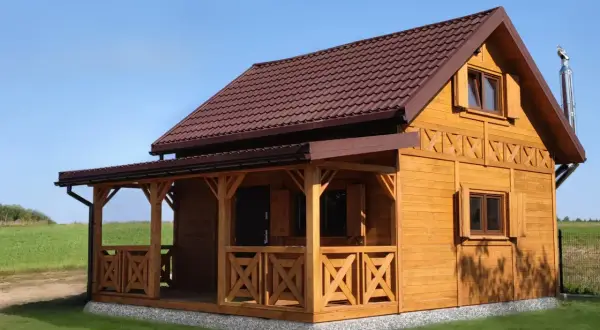 Drewniany domek letniskowy z werandą, idealny na wypoczynek. Zastanawiasz się, ile kosztuje domek letniskowy?