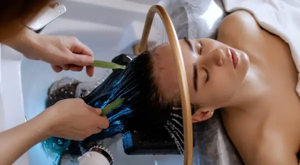 Relaks w trakcie zabiegu head spa. Delikatne masowanie skóry głowy i włosów wodą.