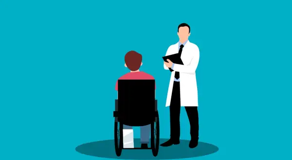 Medico con cartella parla con paziente su sedia a rotelle. Valutazione per la percentuale invalidità per esenzione ticket.