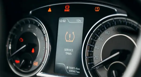 Na desce rozdzielczej świeci się kontrolka cisnienia opon TPMS. Obok widać wskaźnik hamulca i temperatury.