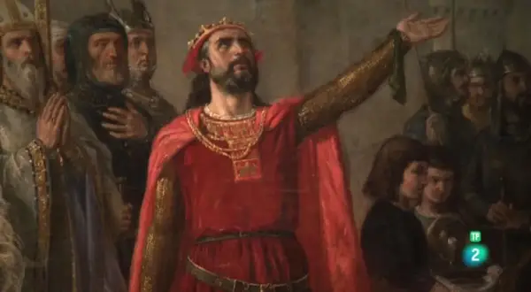 Alfonso V de Portugal, coronado y con capa roja, levanta su mano ante una corte.