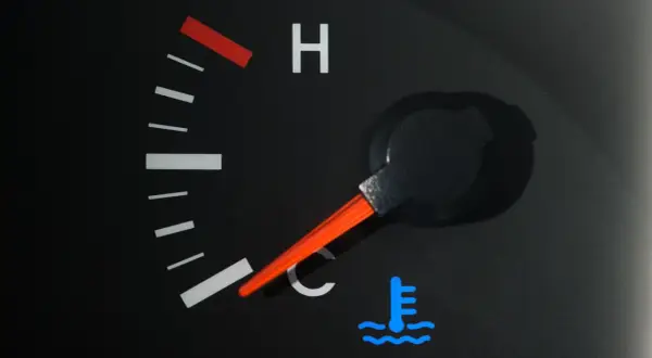 Le voyant bleu de la voiture indique que le moteur est froid. L'aiguille du thermomètre est basse, signe que la température est idéale pour démarrer.