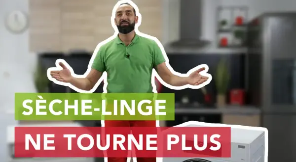 Un homme explique pourquoi son sèche-linge ne tourne plus, devant un appareil et une cuisine floue.