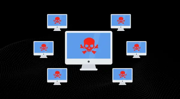 Wiele komputerów z czerwonym symbolem czaszki i skrzyżowanych kości na niebieskim tle, sugerujące atak DDoS.