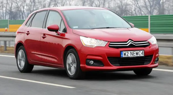 Czerwony Citroen C4 1.6 HDi w ruchu drogowym.
