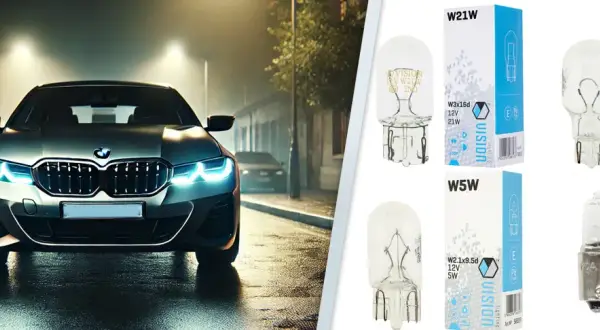 Srebrne BMW z włączonymi światłami pozycyjnymi na mokrej ulicy nocą. Obok żarówki Vision W21W, W16W, W5W, H6W.