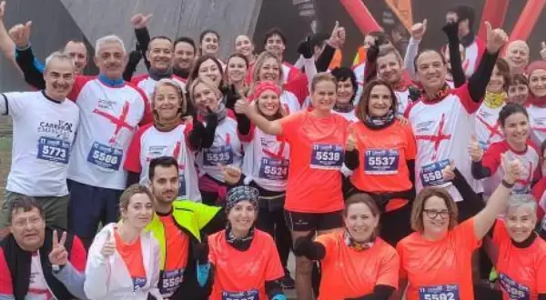 Grupo sonriente posa antes de la carrera de empresas en Zaragoza.