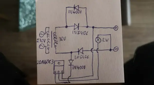 Rysunek schematu prostownika 12V z transformatorem, diodami i żarówką.