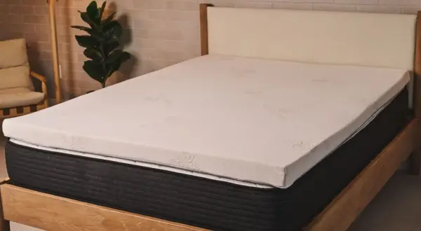 A new mattress with a white topper. This image helps answer: should I put a mattress topper on a new mattress?