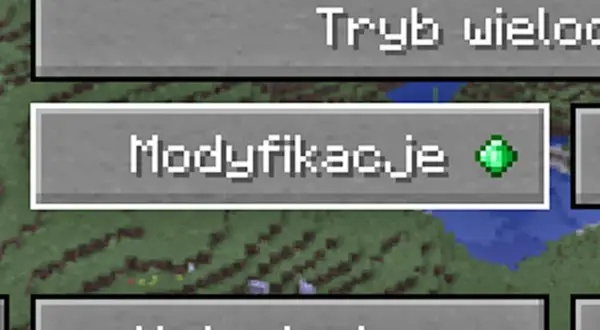 Przycisk "Modyfikacje" w grze Minecraft z zielonym szmaragdem.