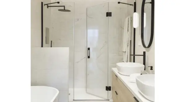 Modern bathroom with a glass shower enclosure, a built-in shower wall, and a freestanding bathtub.
