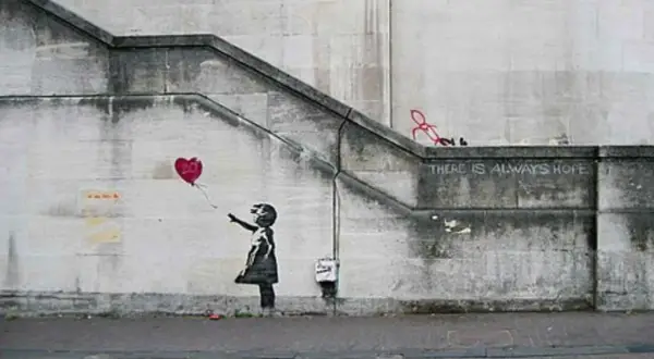 Banksy art piece: Girl letting go of a red heart balloon, with the words "THERE IS ALWAYS HOPE" stenciled above.