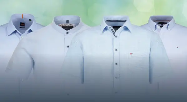 Vier hellblaue Hemden mit verschiedenen hemdkragen arten: Kent-, Steh- und Button-Down-Kragen.
