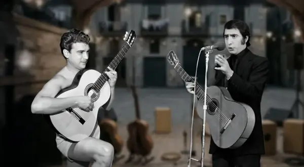 Dos guitarristas interpretan rumba catalana actual en un escenario al aire libre. Uno canta y toca la guitarra, el otro solo toca.