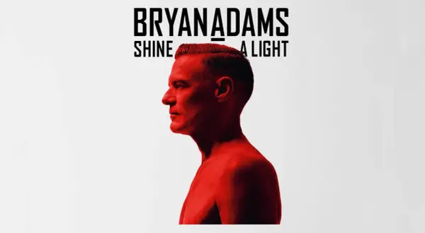 Bryan Adams Shine A Light. Okładka albumu z wizerunkiem artysty w czerwonym świetle.