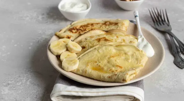 Omlet z bananem, podany z jogurtem i miodem, to idealne śniadanie.