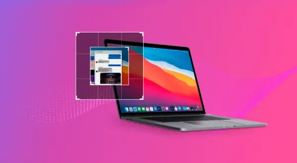 Laptop z otwartym oknem czatu na tle gradientu fioletowo-różowego.