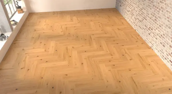 Suelo de madera con disposición en espiga, creando un patrón clásico y elegante.