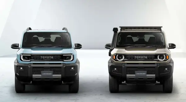 Dwa nowe modele Toyota Land Cruiser, jeden błękitny, drugi złoty, z charakterystycznym grillem i okrągłymi światłami.