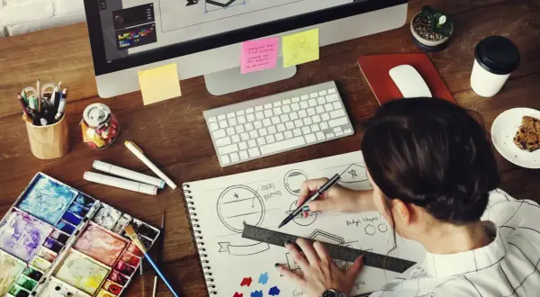 A graphic designer sketches logo ideas, a key step in learning how to make money as a graphic designer.
