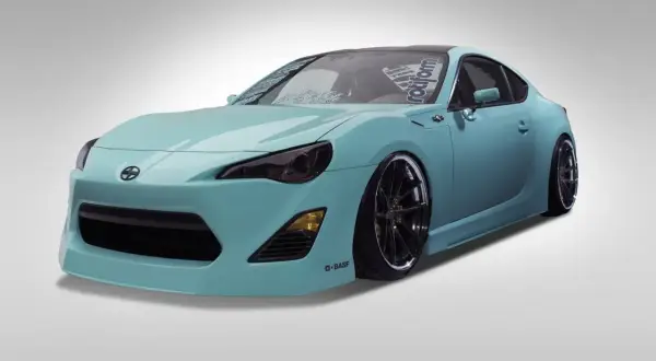 Turkusowy Scion FR-S z czarnymi felgami i przyciemnionymi światłami, gotowy do jazdy.