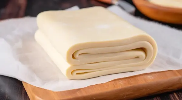 Pieghe perfette di pasta sfoglia pronte per la cottura. Un impasto che promette sfogliature croccanti e dorate.