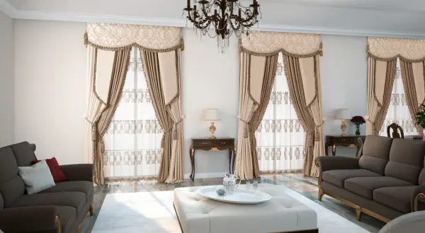 Elegancki salon w stylu vintage z ciemnobrązowymi sofami, pufą i bogato zdobionymi zasłonami.