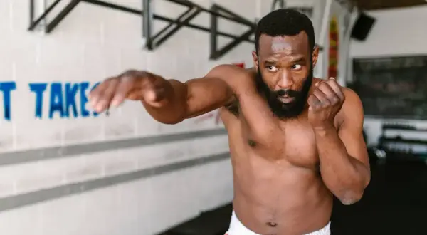 A man practices shadow boxing, demonstrating the physical and mental shadow boxing benefits.