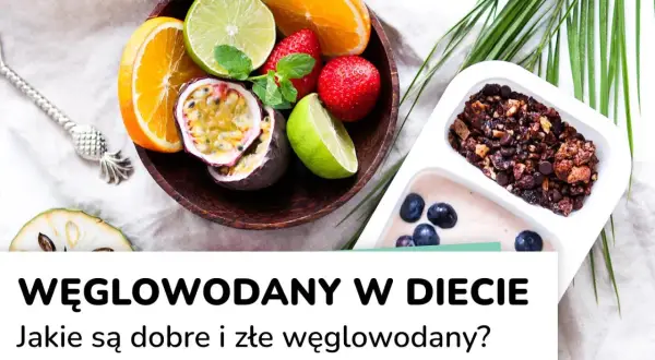 Miska z owocami (pomarańcza, limonka, marakuja, truskawki) i pojemnik z jogurtem i granolą.