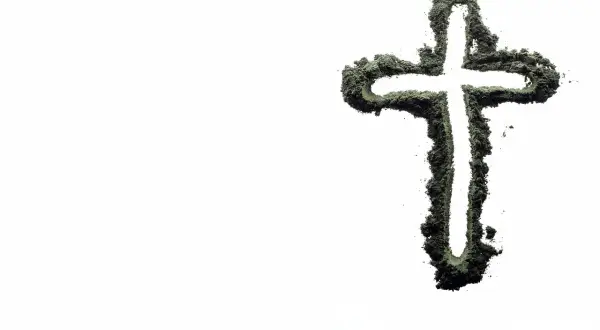 Krzyż z zielonego proszku, symbolizujący życie i wiarę, na tle pustki. Czy inseminacja może być zgodna z naukami kościoła?