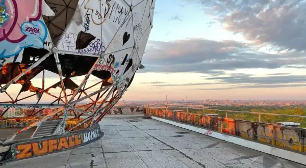 Graffiti-bedeckte Kuppel des Teufelsberg Berlin mit Blick auf die Stadt bei Sonnenuntergang.